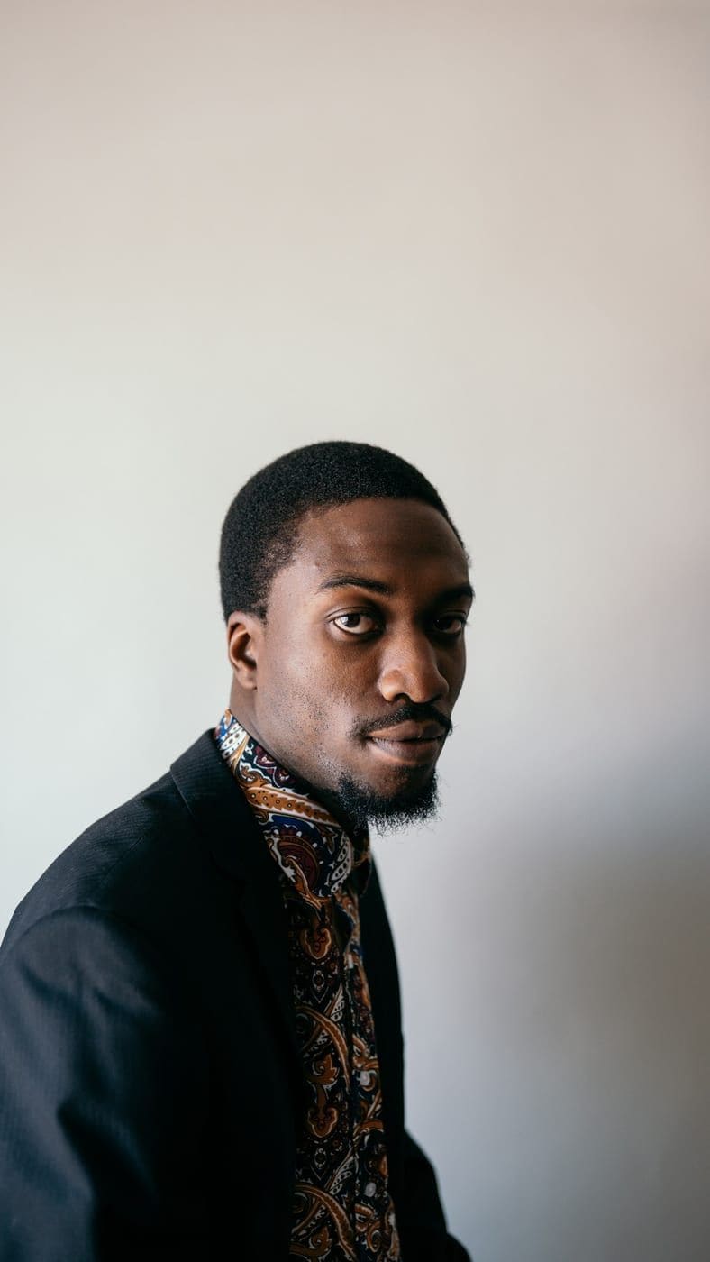 Marcus Amory in a dark suit, photographed in natural light